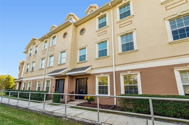 a view of a dining room with furniture a chandelier and wooden floor