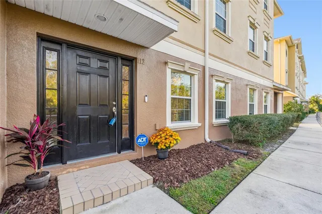 a living room with furniture a large window and wooden floor