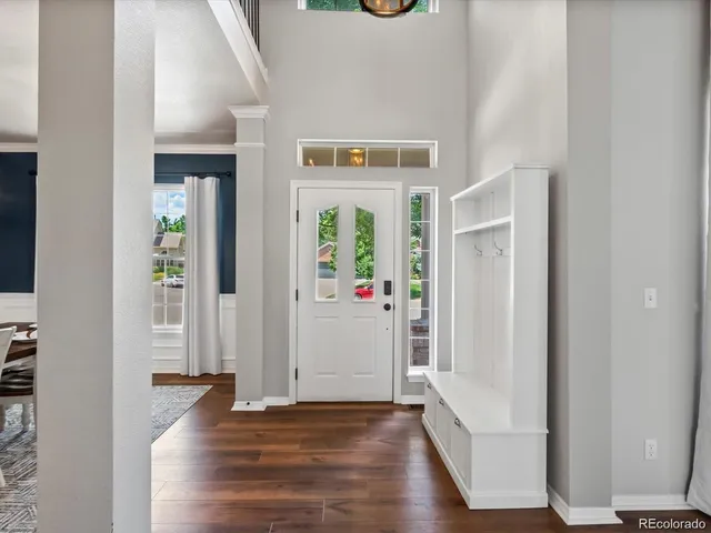 hallway with wooden floor and windows