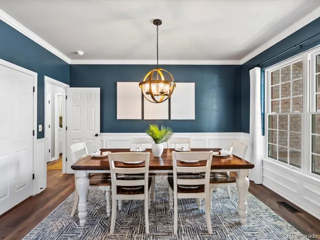 a view of a dining room with furniture window and wooden floor