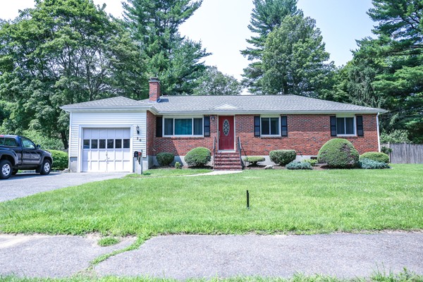 a front view of house with yard and green space