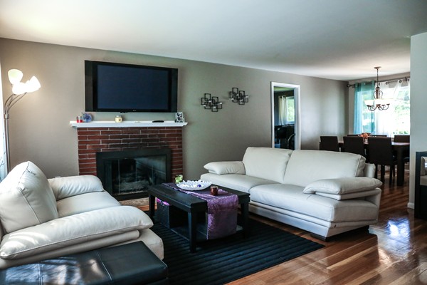 26 Livoli Road Framingham, MA 01701 - Photo 2 of 13 a living room with furniture a flat screen tv and a fireplace