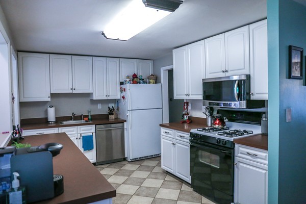 26 Livoli Road Framingham, MA 01701 - Photo 5 of 13 a kitchen with stainless steel appliances a stove a sink and a refrigerator