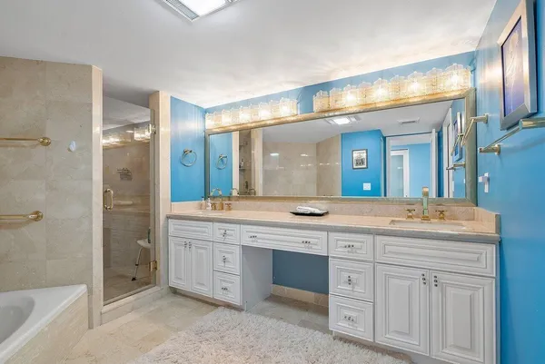 a bathroom with a bathtub shower sink and toilet
