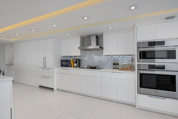a bathroom with a tub a potted plant and a sink