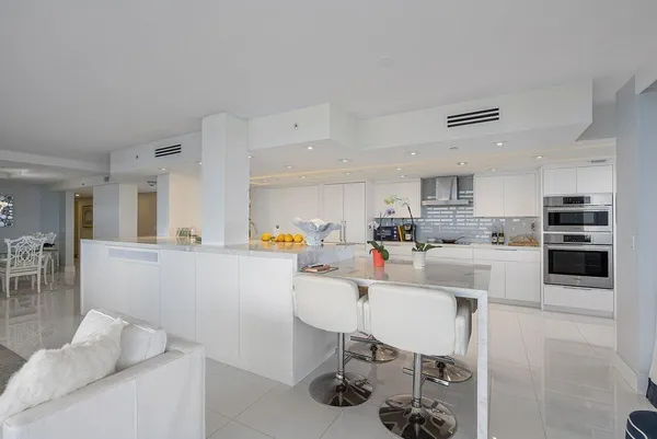 a dining room with furniture and a chandelier
