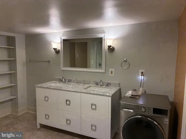 a bathroom with a sink a light fixture and a mirror