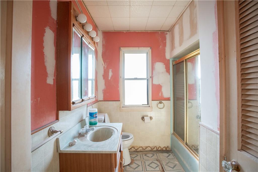802 Summit Avenue Monaca, PA 15061 - Photo 8 of 23 a bathroom with a sink a toilet and a mirror