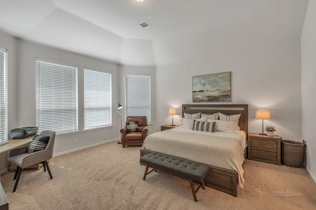 a bedroom with a bed and a couch