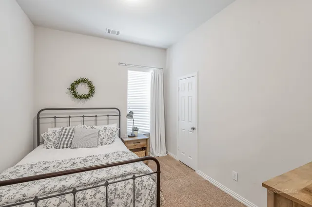 a bedroom with a bed and a window