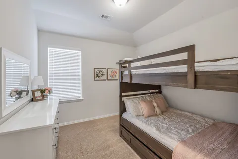 a bedroom with a bed and window