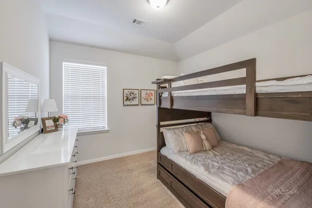 a bedroom with a bed and window