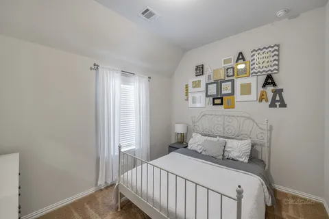 a bedroom with a bed and cabinets
