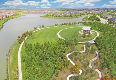 an aerial view of a house with outdoor space and lake view