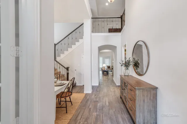 a view of entryway with wooden floor and a front door