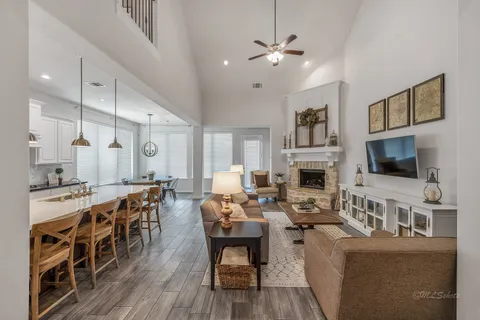 a living room with fireplace furniture and a flat screen tv