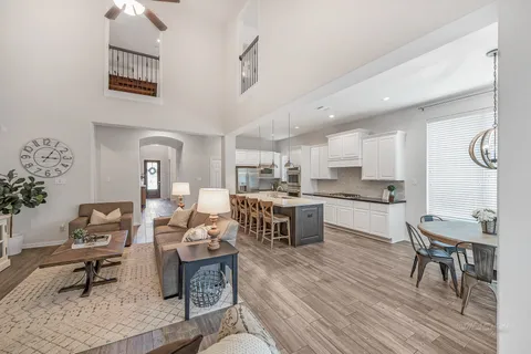 a living room with stainless steel appliances kitchen island granite countertop furniture and a kitchen view