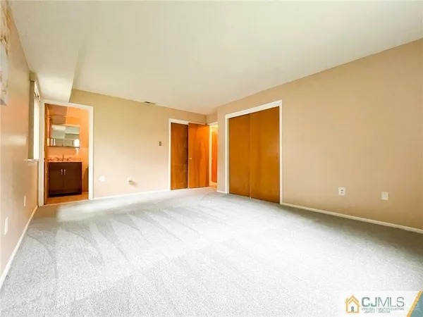 an empty room with a window and bathroom