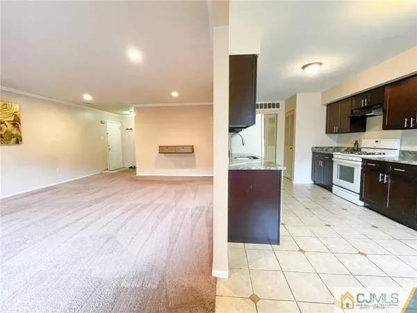 a view of kitchen with cabinets microwave and stove