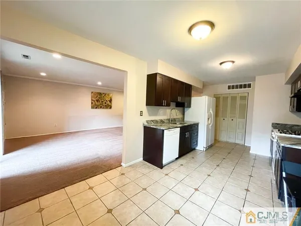 a kitchen with a refrigerator and a counter top space