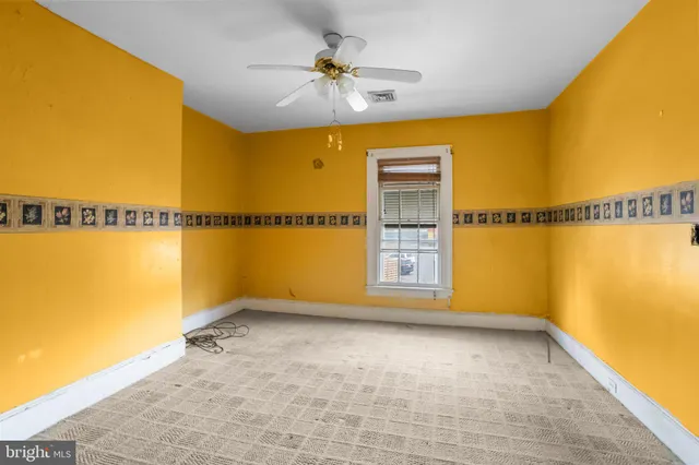 a view of a room with wooden floor and a bathroom