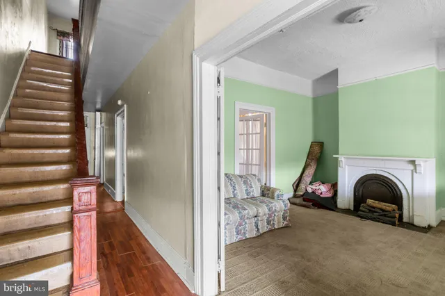 a view of a livingroom with furniture and staircase