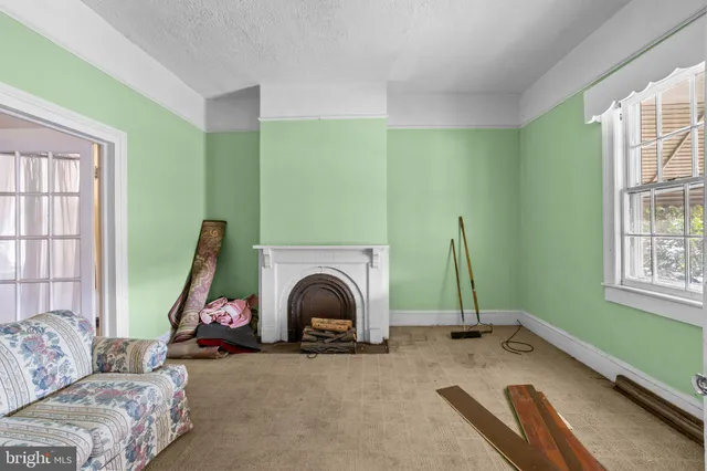 a view of a livingroom with furniture and a window