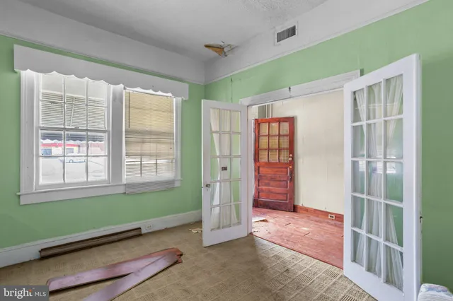 a kitchen with a stove and white cabinets