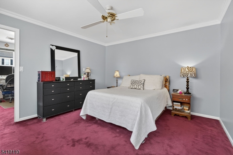 710 West Elm Street Linden, NJ 07036 - Photo 13 of 24 a bedroom with a bed and a chandelier
