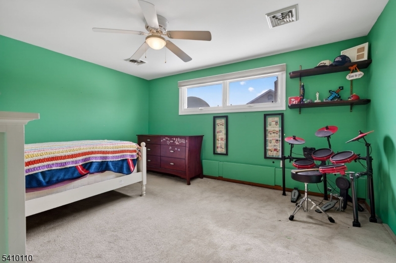 710 West Elm Street Linden, NJ 07036 - Photo 17 of 24 a bedroom with a bed and a chair