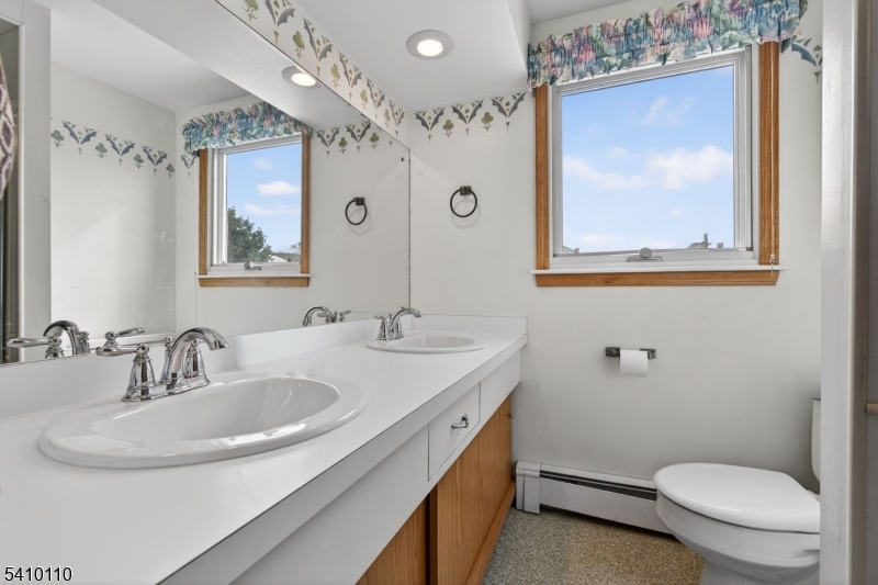 710 West Elm Street Linden, NJ 07036 - Photo 20 of 24 a bathroom with a toilet a sink and mirror