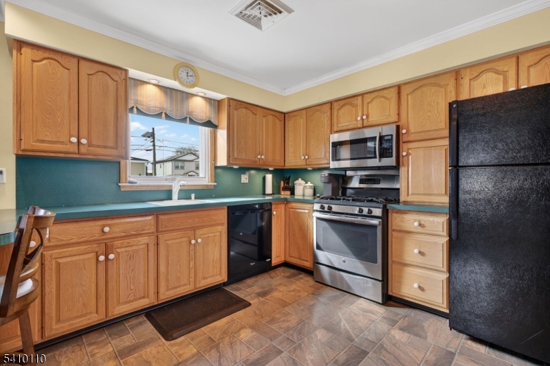710 West Elm Street Linden, NJ 07036 - Photo 8 of 24 a kitchen with stainless steel appliances granite countertop a refrigerator sink and cabinets