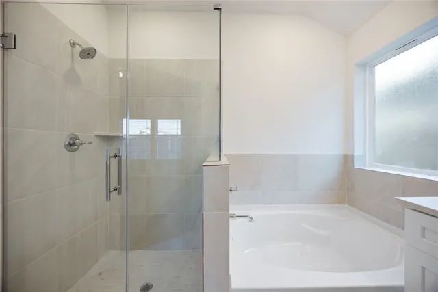a bathroom with a bathtub and a shower