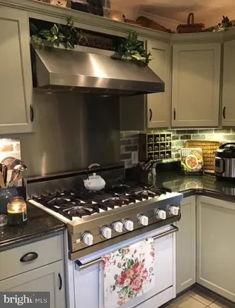 a kitchen with a stove and a cabinets