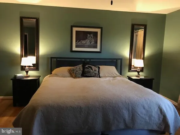 a bedroom with a bed and lamp