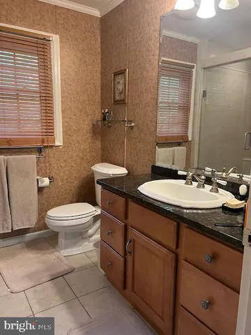 a bathroom with a sink toilet and mirror