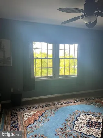 a room with window and a rug