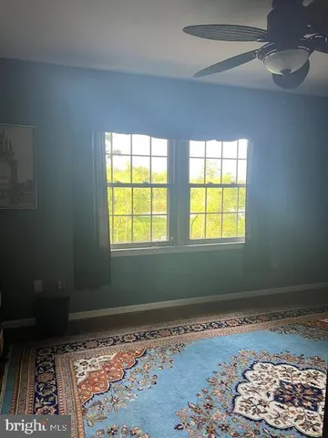 a room with window and a rug