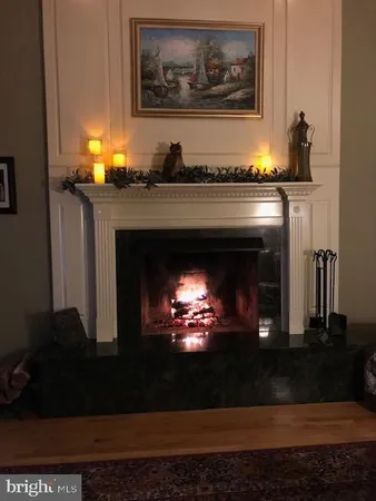 a bathroom with a fireplace and a lamp on table