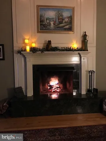a bathroom with a fireplace and a lamp on table