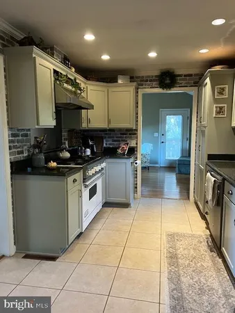 a kitchen with a sink a counter top space cabinets and stainless steel appliances