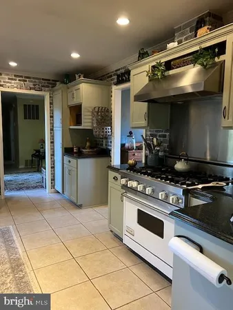 a kitchen with stainless steel appliances granite countertop a stove and a sink