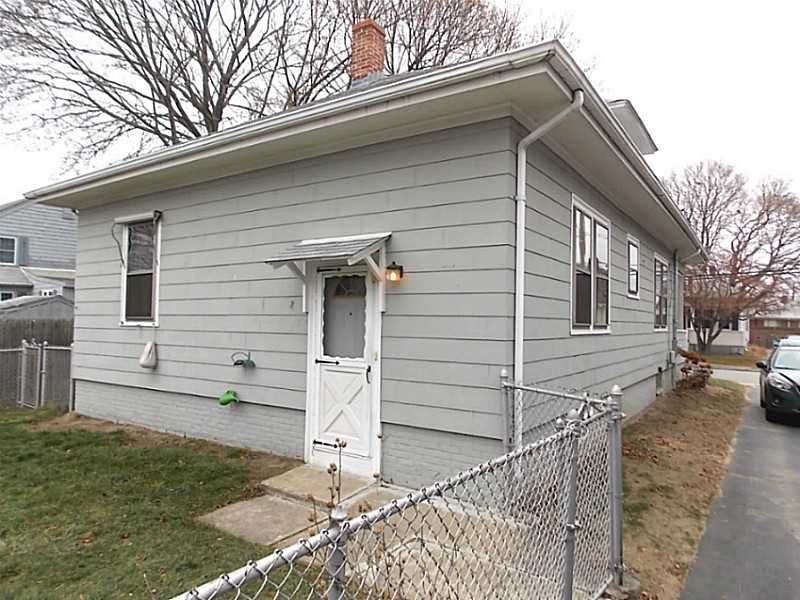 56 Richland Road Cranston, RI 02910 - Photo 20 of 20 Exterior Back. Rear and side view of the home near the driveway.