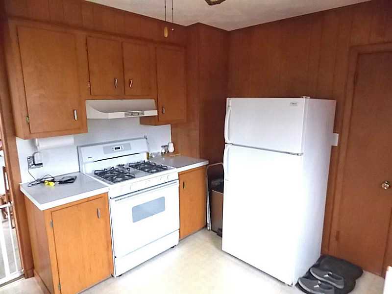 56 Richland Road Cranston, RI 02910 - Photo 9 of 20 Kitchen. The Kitchen is applianced with natural gas newer rage, refrigerator, and new SS dishwasher. A new kitchen sink will be installed prior to closing.