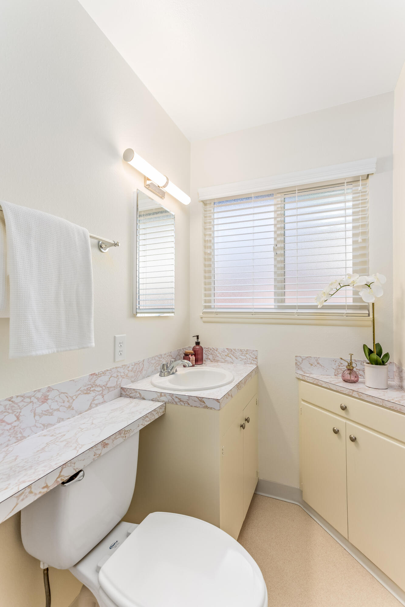 7111 Madera Drive Goleta, CA 93117 - Photo 15 of 24 a bathroom with a granite countertop toilet sink and mirror