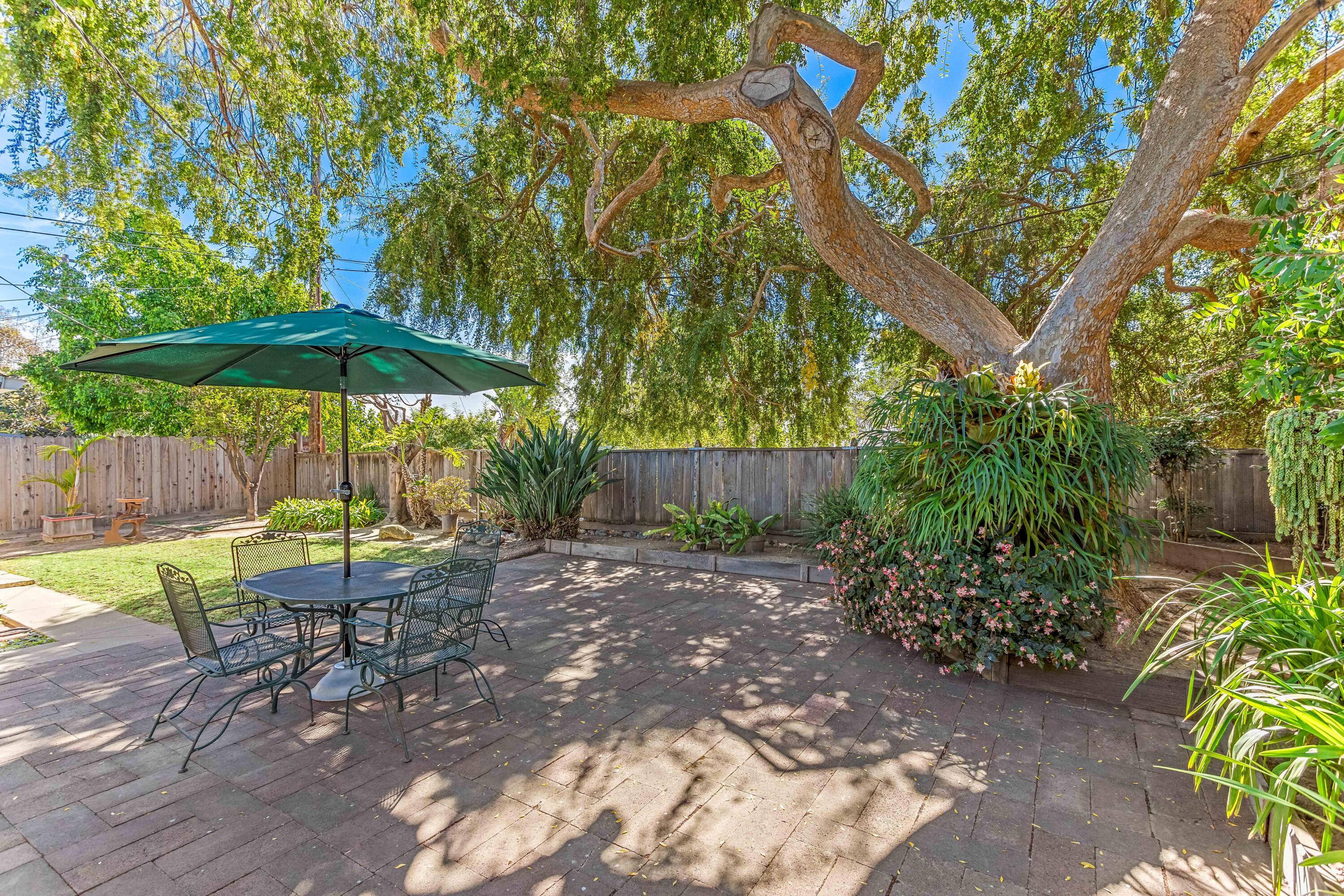 7111 Madera Drive Goleta, CA 93117 - Photo 20 of 24 a view of a table and chairs under an umbrella in backyard