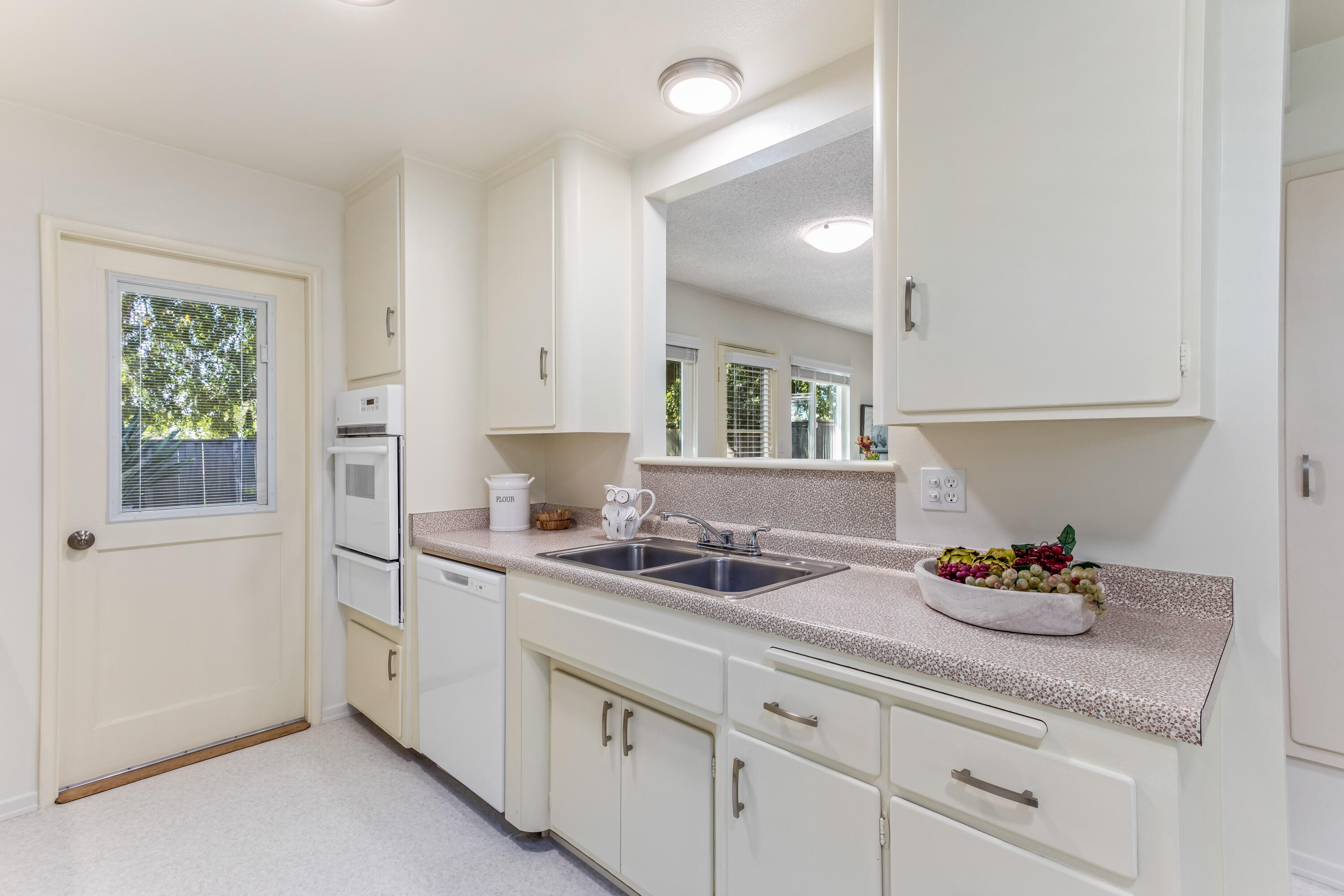 7111 Madera Drive Goleta, CA 93117 - Photo 9 of 24 a kitchen with stainless steel appliances granite countertop a sink stove and cabinets