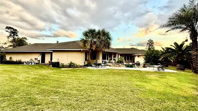 a view of a house with swimming pool and sitting area