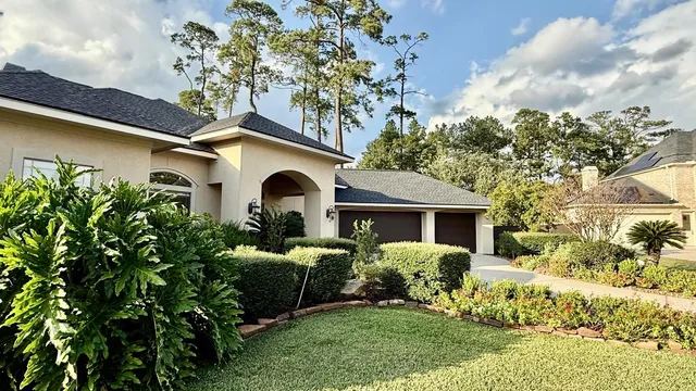 a front view of a house with garden