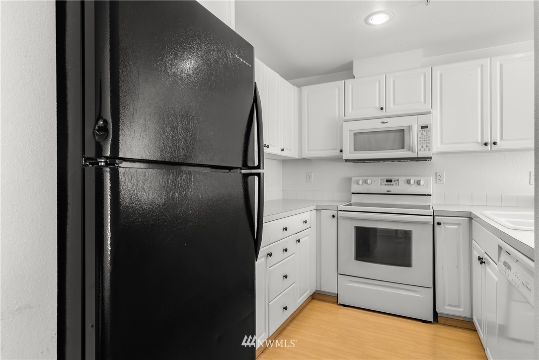 1160 Monroe Avenue Northeast, Unit A4 Renton, WA 98056 - Photo 2 of 26 a kitchen with cabinets and stainless steel appliances